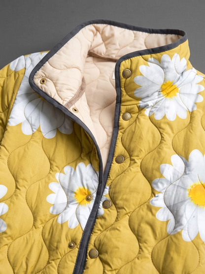 Close view of the stand collar, brass snaps and cream quilted lining on the Georgiana jacket