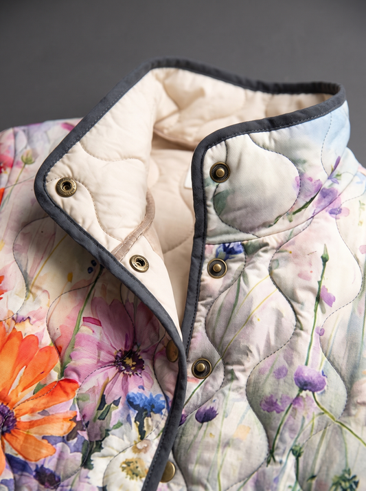 Close view of the stand collar, brass snaps and cream quilted lining on the Evangeline jacket