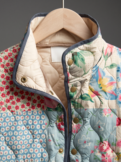Close view of the stand collar, brass snaps and cream quilted lining on the Emmeline jacket