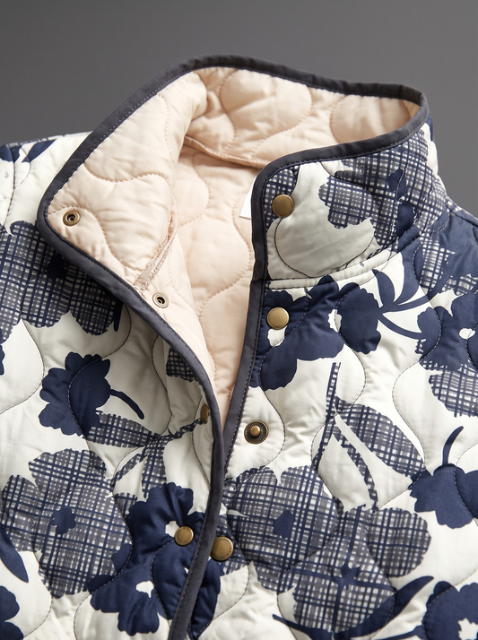 Close view of the stand collar, brass snaps and cream quilted lining on the Adela jacket