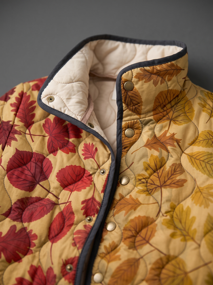 Close view of the stand collar, brass snaps and cream quilted lining on the Arabella jacket