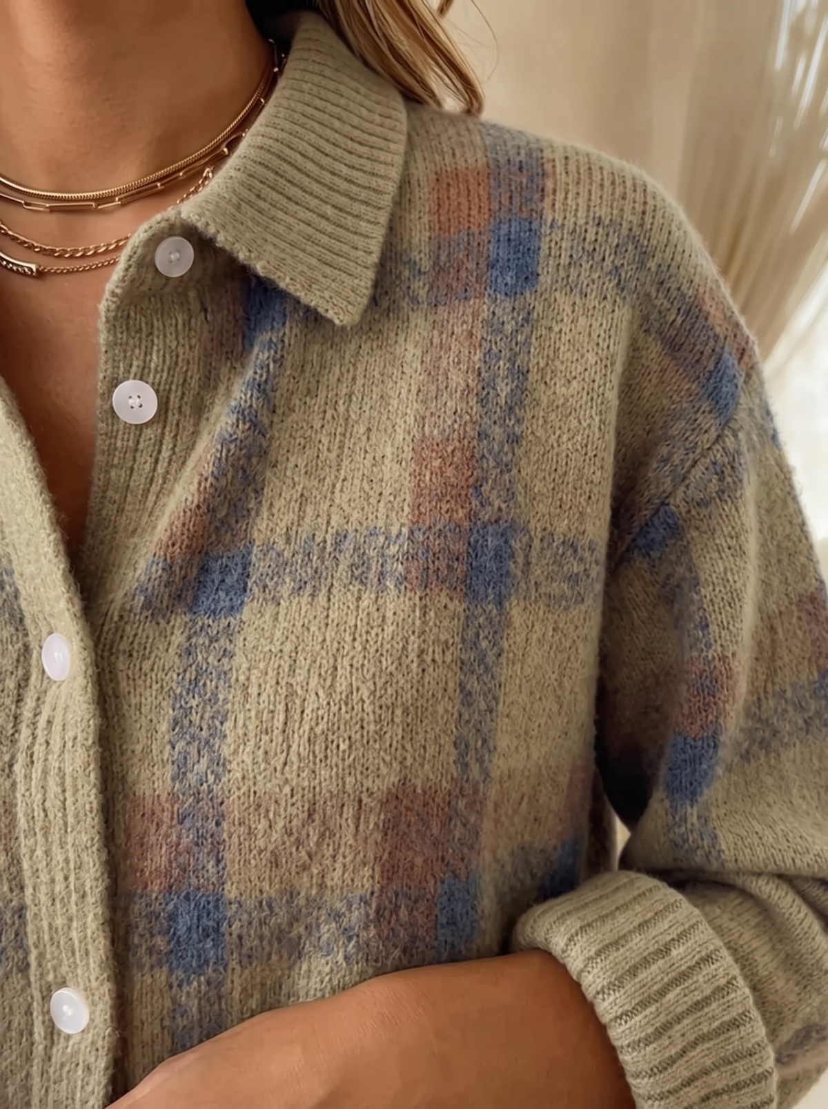 Close view of the collar, buttons and ribbed cuff on the Wilma plaid cardigan in taupe