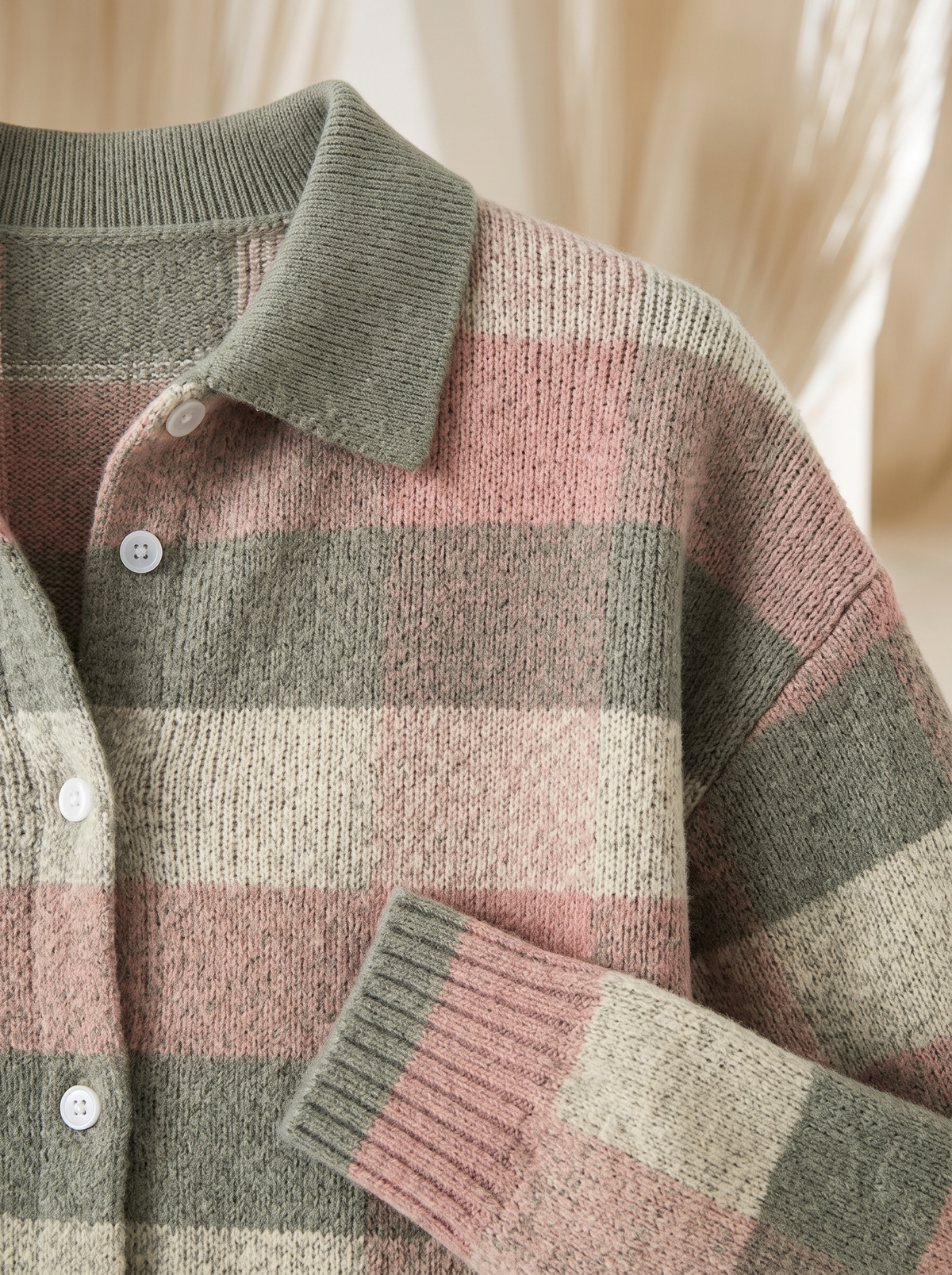 Close view of the collar, buttons and ribbed cuff on the Hattie plaid cardigan
