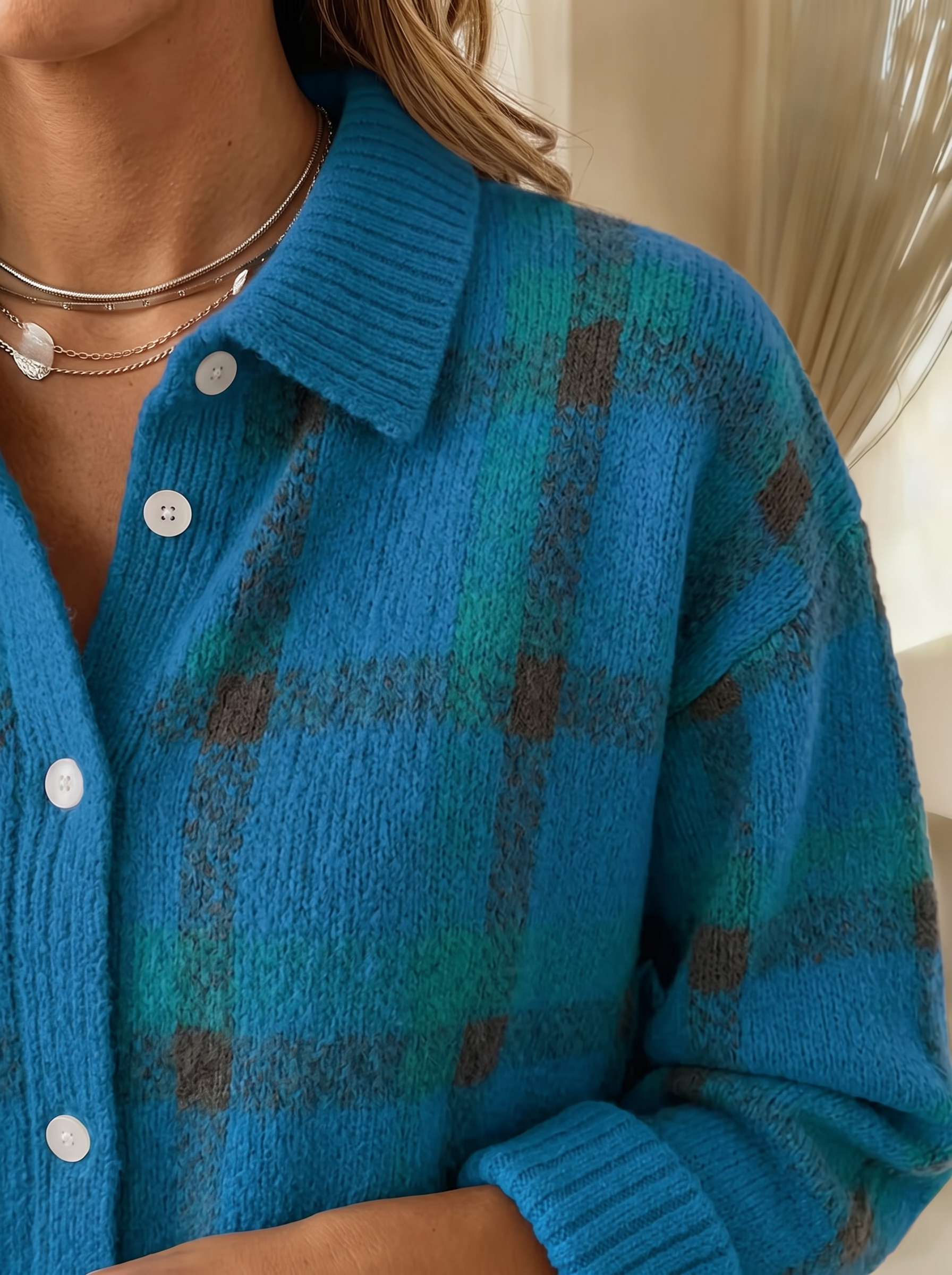 Close view of the collar, buttons and ribbed cuff on the Lois plaid cardigan