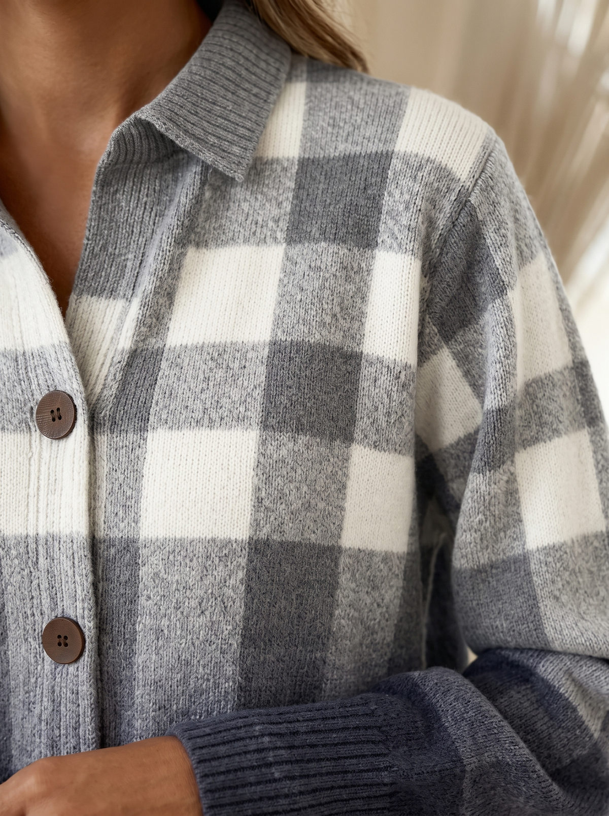 Close view of the collar, brown buttons and ribbed cuff on the Gladys plaid cardigan