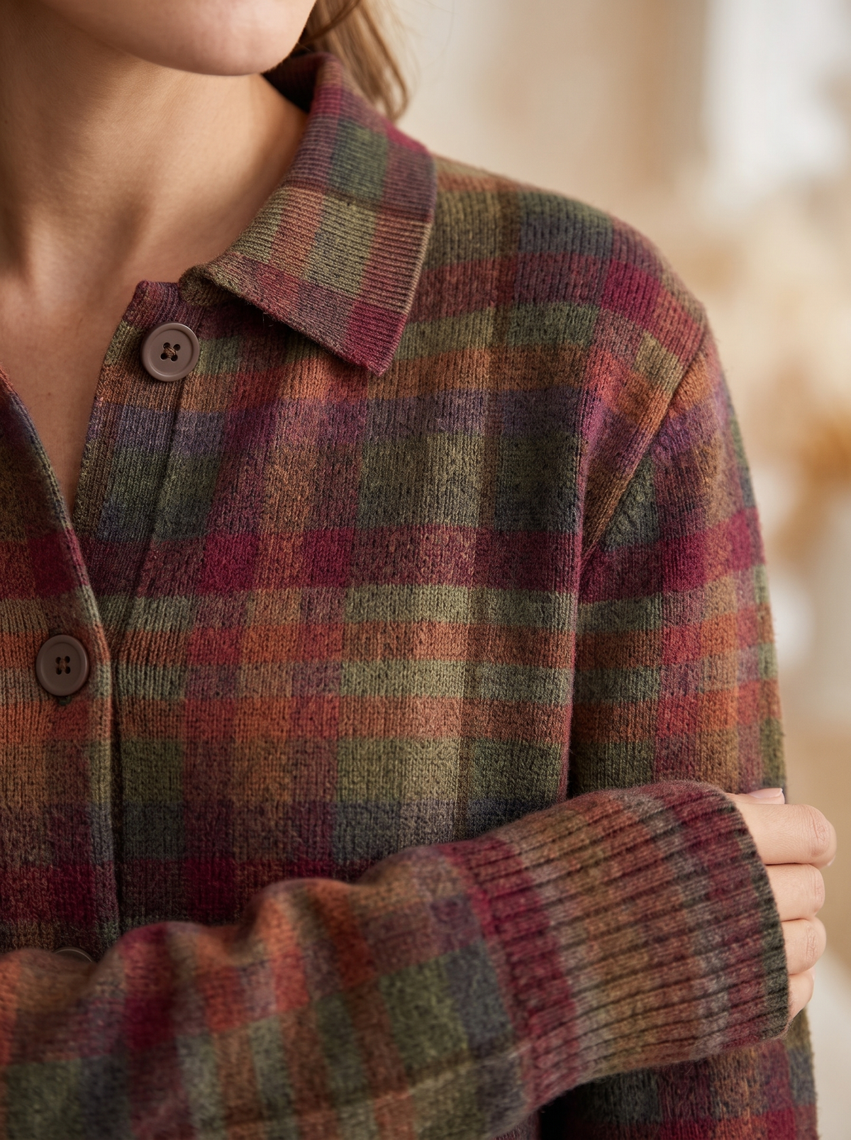 Close view of the collar, brown buttons and ribbed cuff on the Cornelia plaid cardigan