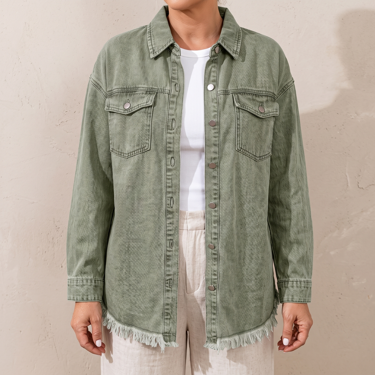 Dottie raw hem denim jacket in olive green, worn open over a white top
