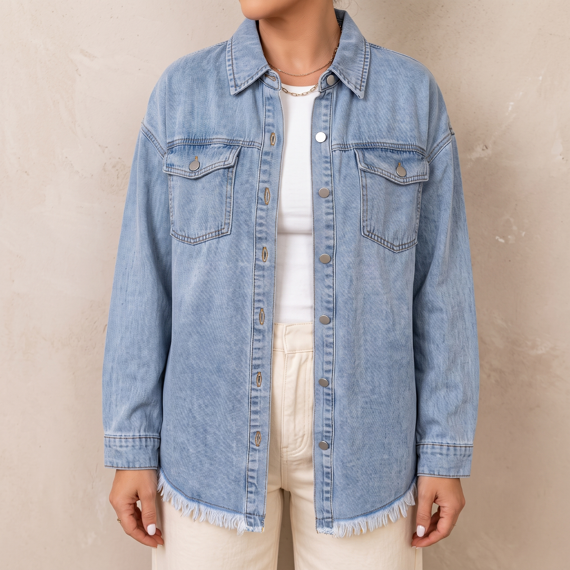 Dottie raw hem denim jacket in light blue, worn open over a white top