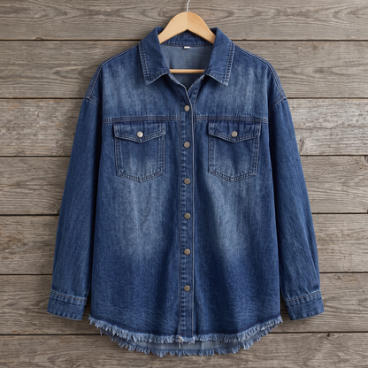 Dottie raw hem denim jacket in dark blue, shown on a wooden hanger against a weathered wood plank wall
