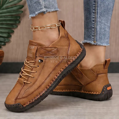 Lena comfort sneaker in Brown, showing the wide rounded toe and hand-stitched sole