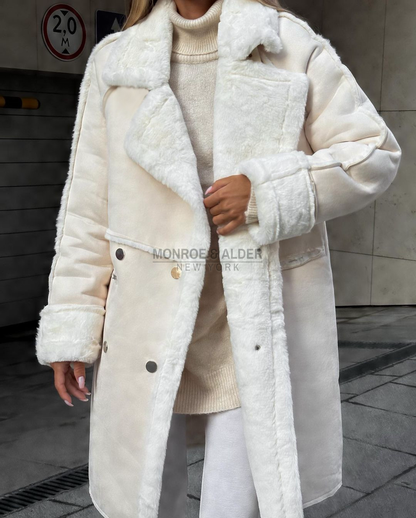 Close view of the ivory Lenora coat with plush cuffs and metal snap buttons
