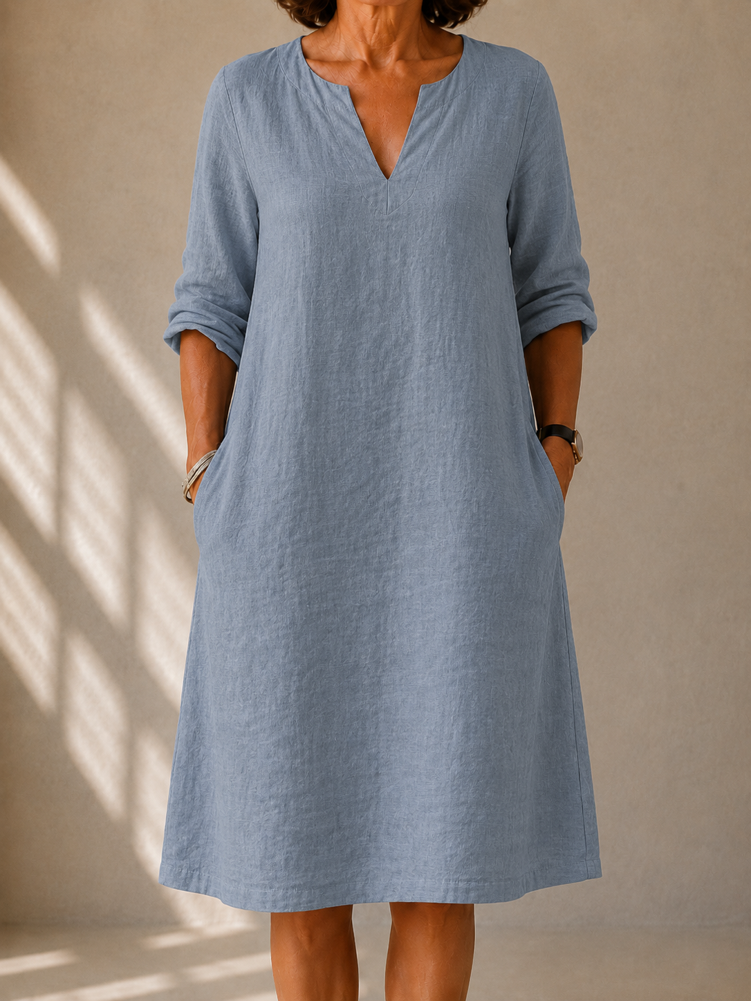Edith dress in Dusty Blue, front view showing the notched neckline and rolled sleeves