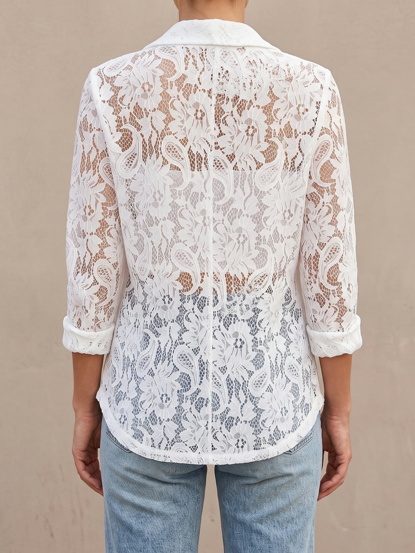 Back of the white Lucy lace blazer showing the semi-sheer lace back and curved hem