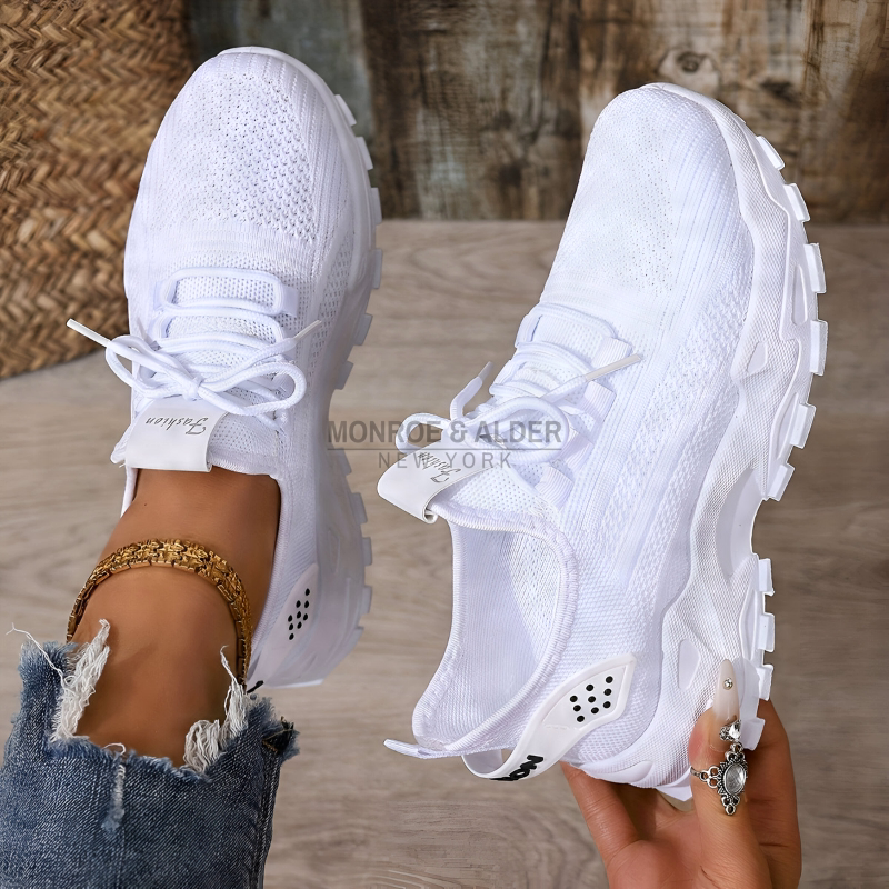 Molly sneaker in white, held in hand