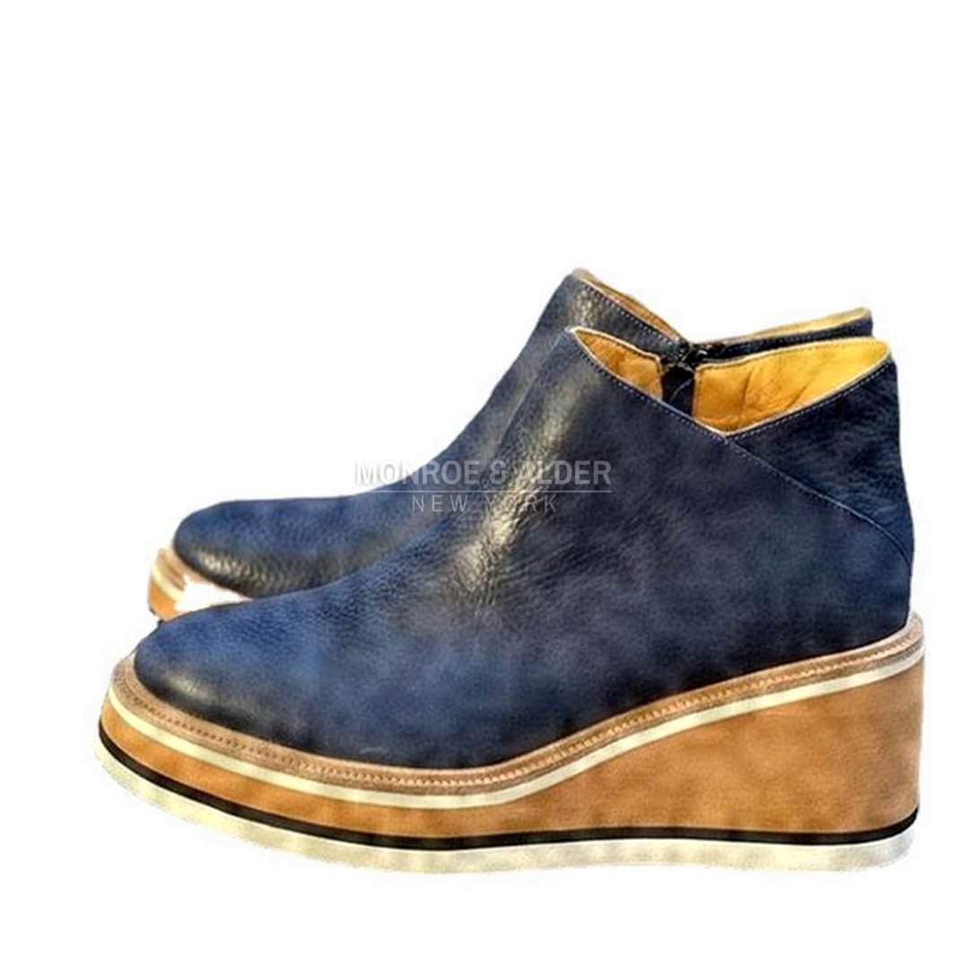 Nina ankle boot in navy, side view of the stacked wedge sole