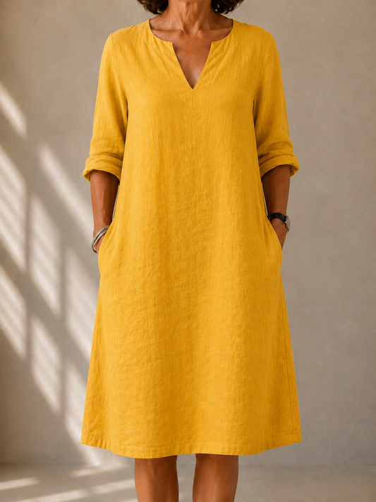 Hazel dress in Mustard, front view showing the split V-neck and rolled sleeves