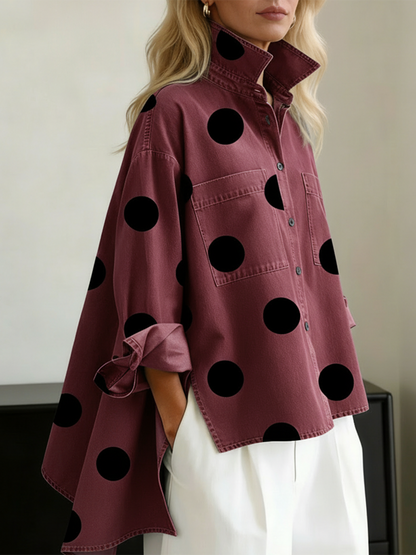 Burgundy polka dot overshirt with black dots, worn over white trousers