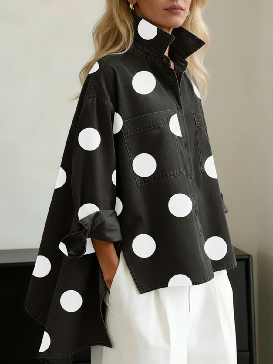 Black polka dot overshirt with white dots, worn over white trousers