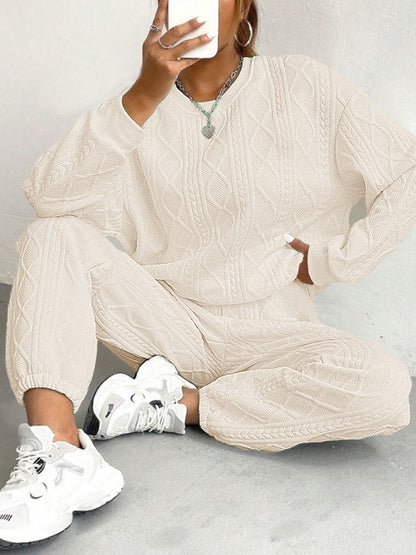 Paulette cable-knit lounge set in cream, full look with the crew neck sweater and cuffed pants
