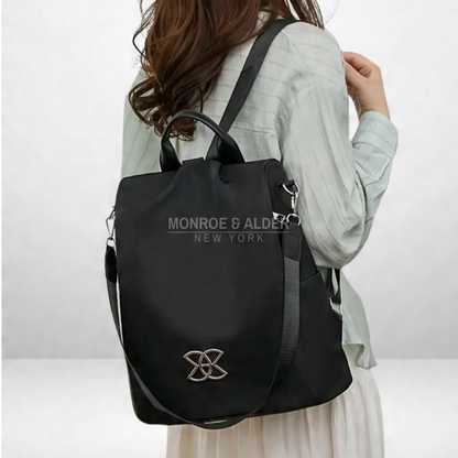 Rosanne anti-theft bag in black worn on the back