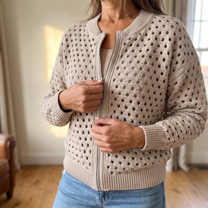 Close view of the open square-cutout knit and the full-length silver zipper