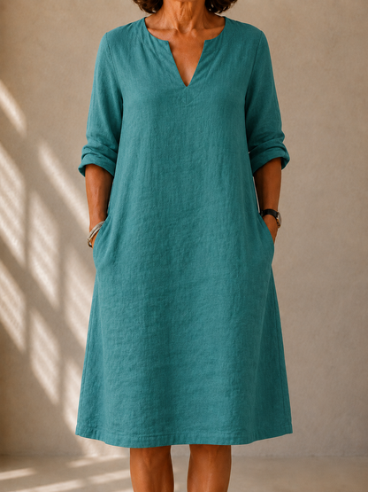Irene dress in Teal, front view showing the split V-neck and rolled sleeves