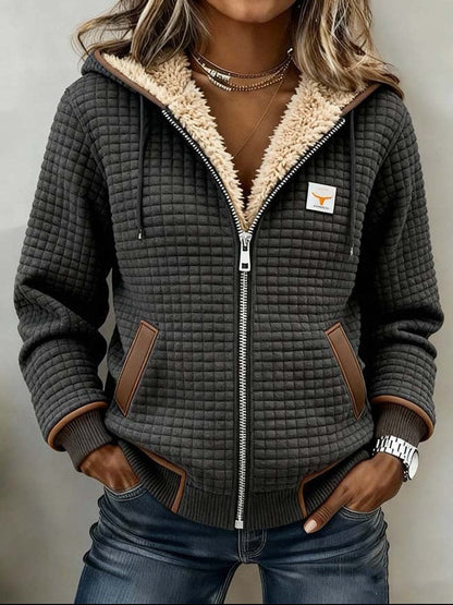 Wanda sherpa-lined quilted jacket in charcoal, front view worn with jeans