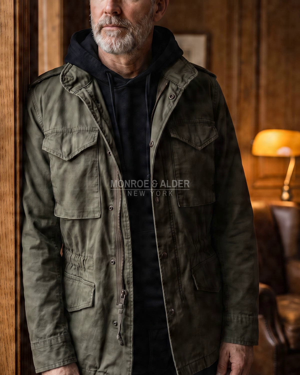 Man wearing the Wyatt field jacket in Olive over a hoodie